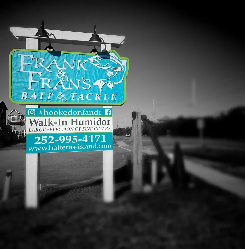 Frank & Fran's Bait & Tackle blue roadside sign on NC Highway 12 in Avon, Hatteras Island, North Carolina
