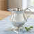 Handcrafted pewter cider pitcher with elegant handle.
