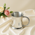 Pewter tankard with twisted handle design.