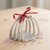 Pewter stirrup napkin rings with red ribbon.