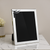 Polished pewter frame with mortarboard decoration.