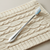 Sterling silver baby toothbrush with blue bristles.