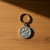 Pewter key ring with raised paw print design.
