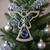 Pewter angel ornament with sapphire-toned jewel.