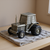 Pewter tractor-shaped coin bank with details.