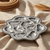 Cast aluminum oyster griller with ten compartments.
