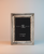 Beaded silver photo frame with elegant border.