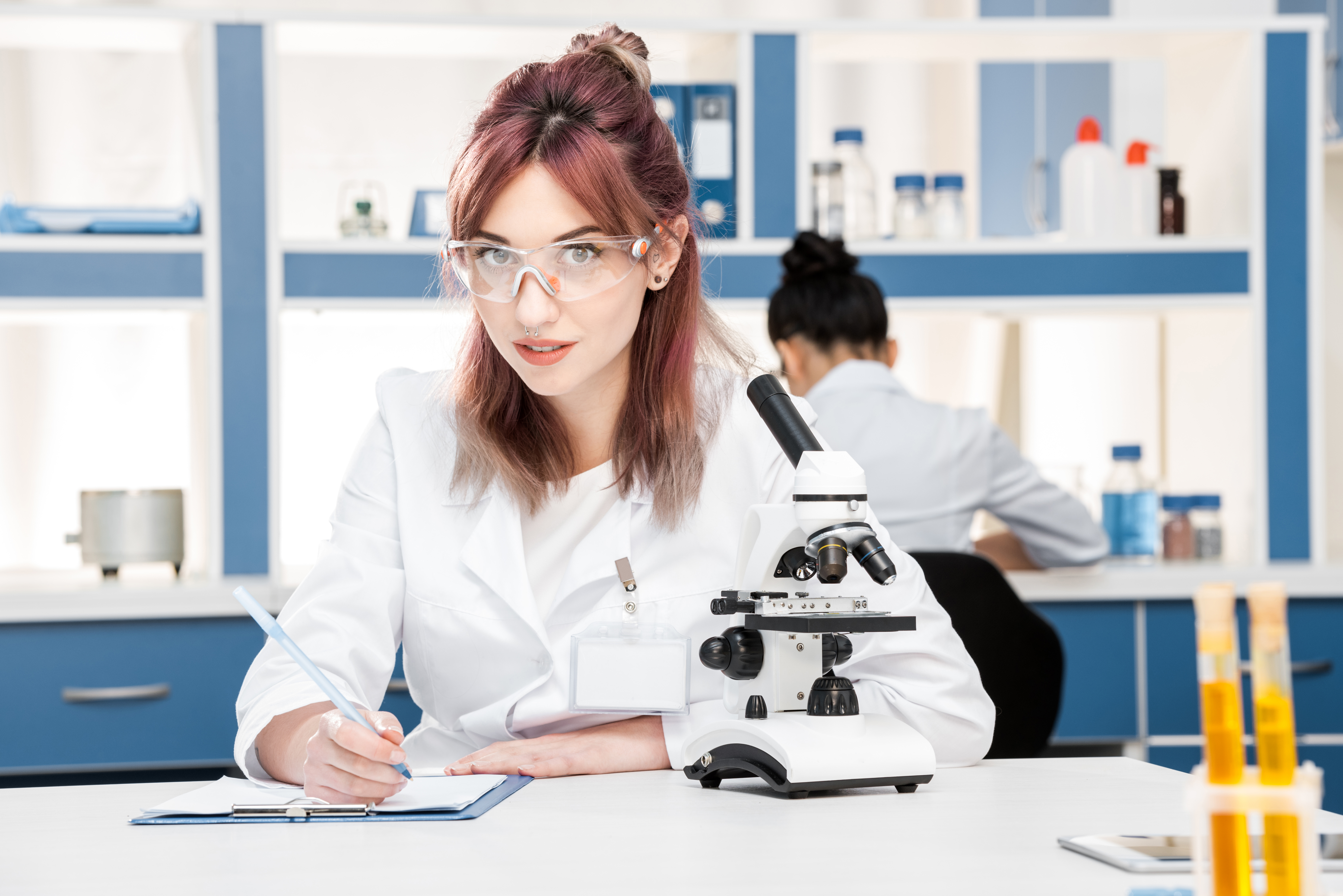 young-scientist-in-lab-coat-working-with-microscop-2022-06-24-13-12-38-utc.jpg