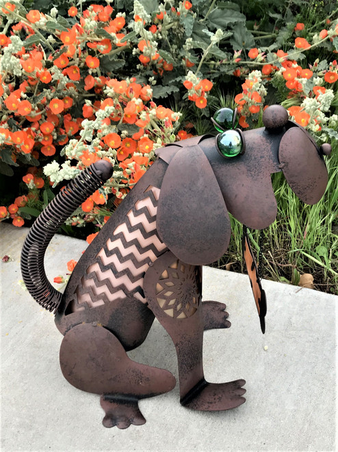 Animal shaped solar light is 13 inches tall, with floppy ears, huge green marble eyes, and a spiral tail.