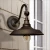 Solar barn light has a Dark Bronze matte finish, and includes hardware for a solar wall light installation.