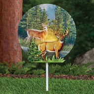 Deer solar light is made from metal and acrylic, includes two deer, pine trees and mountains, and stands 15 inches high installed.