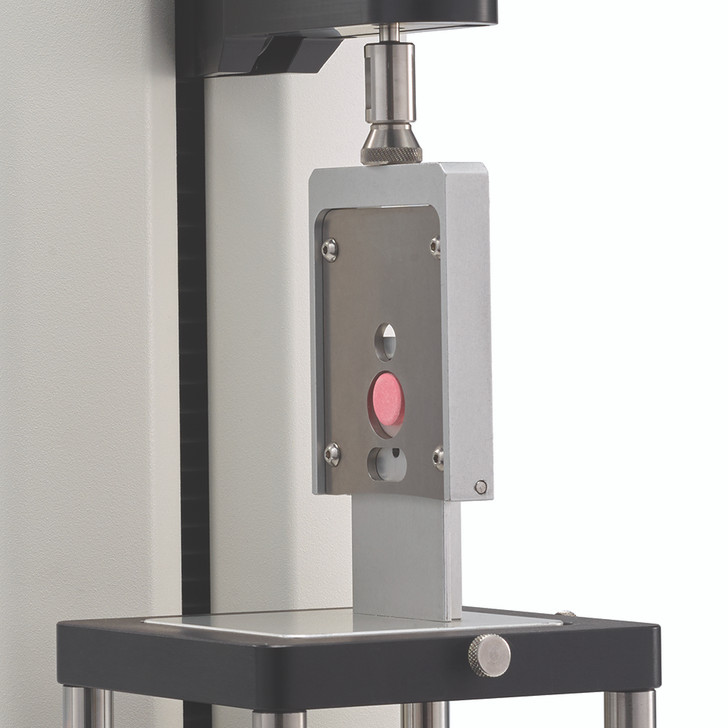 Measure shear strength of two-part tablet or capsule using guillotine blade.