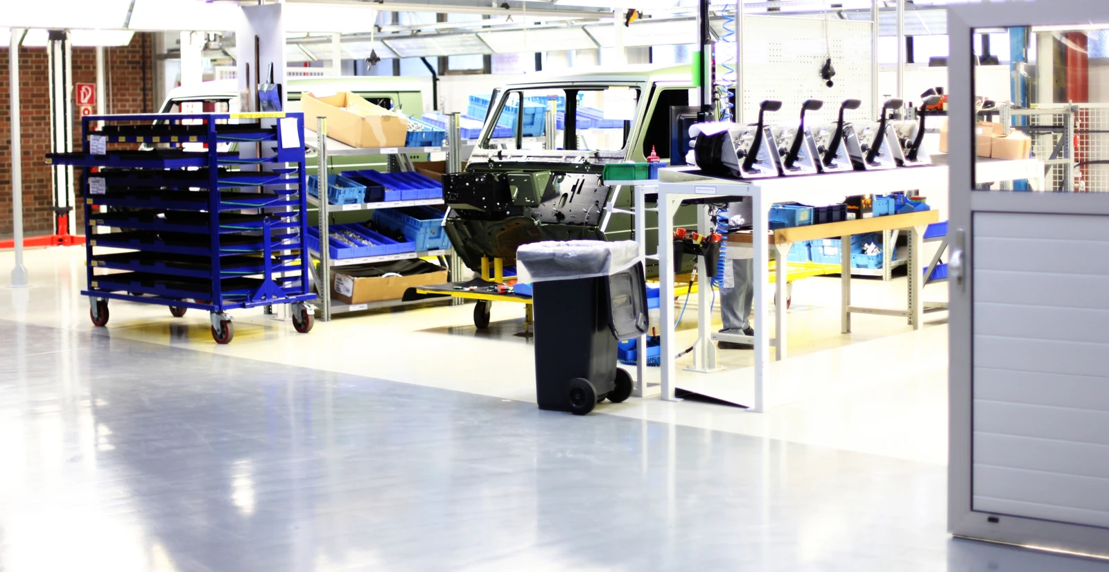 A work truck manufacturing floor with kanban bins full of inventoried parts.