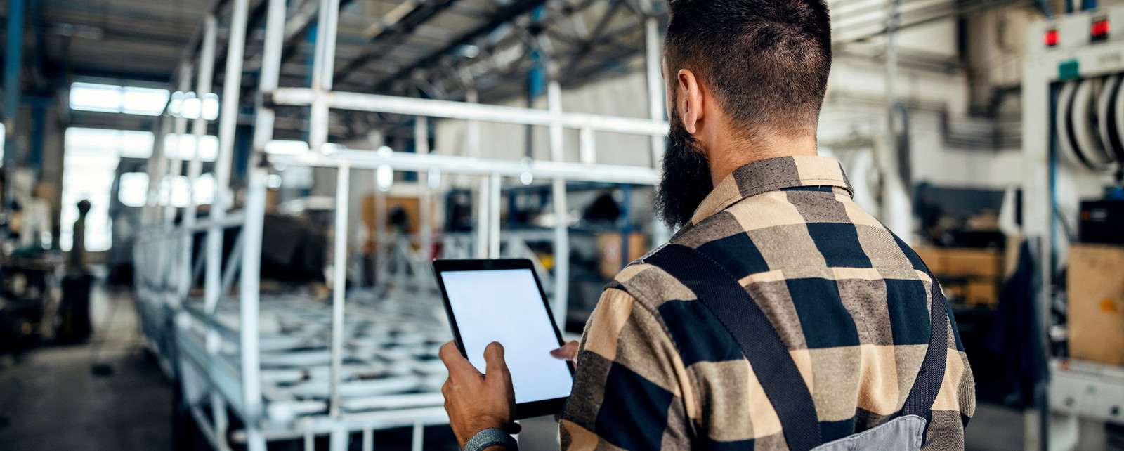Engineer reviewing product in a factory.