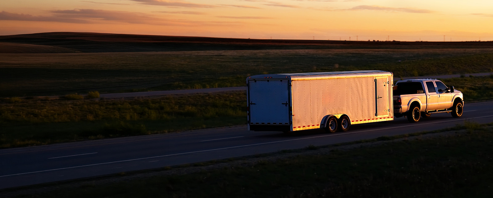 Trailer  being pulled at sunset