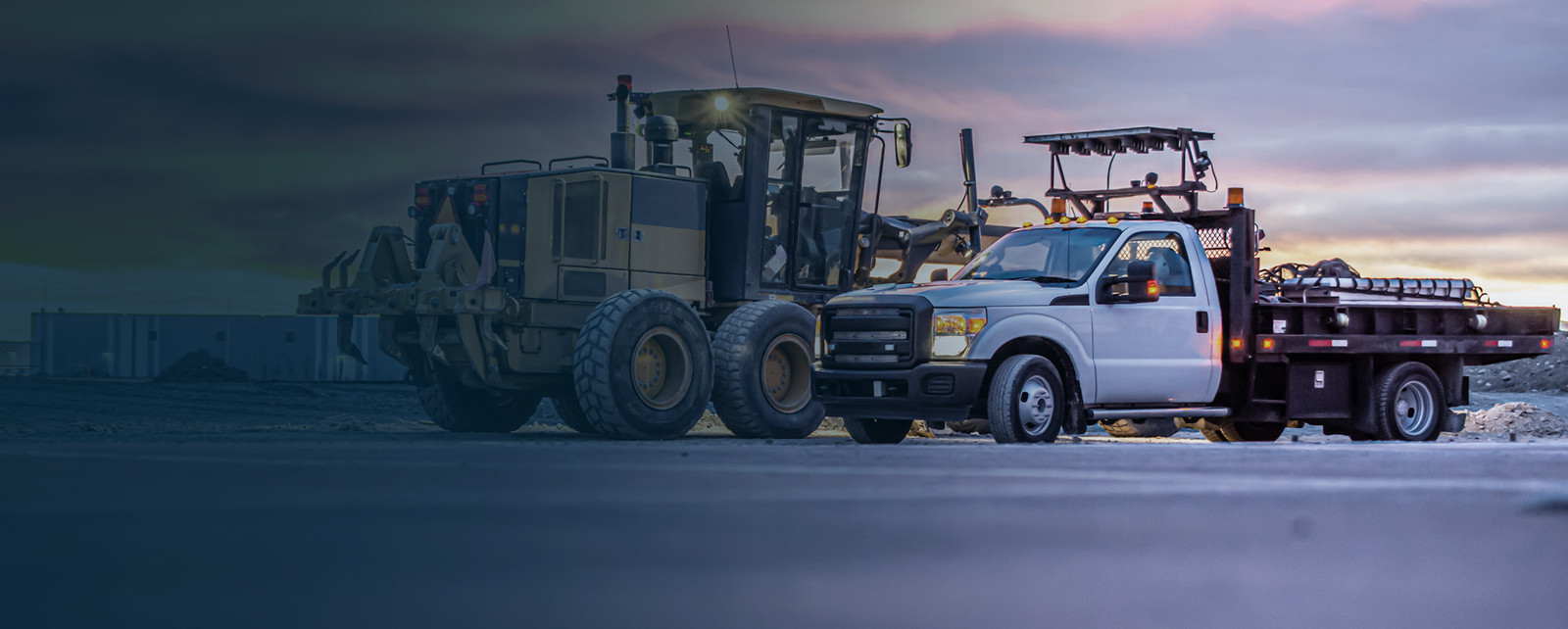 Two work trucks on a construction site. Visit Austin Hardware at Work Truck Week booth 4605. 