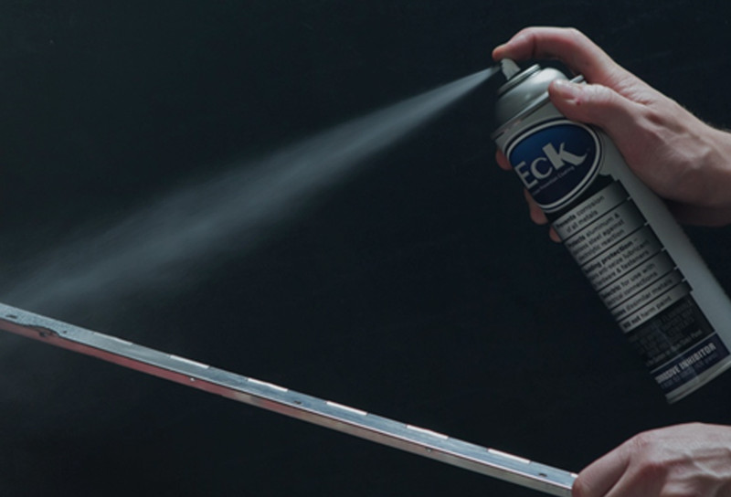 Spraying Eck Corrosion Protectant on hinge