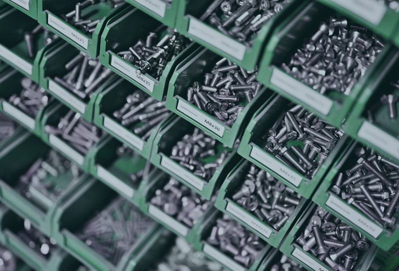 Bins filled with various fasteners in manufacturing