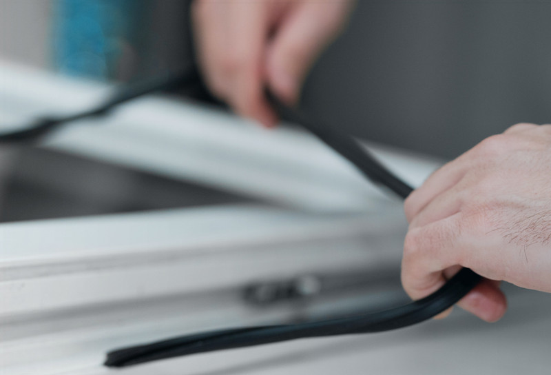 Close up of man applying gasket trim