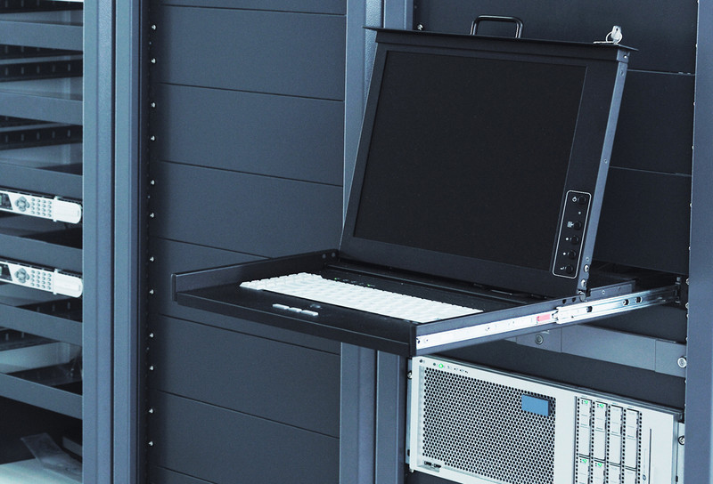 Image of computer on pull out shelf in server room showing sliding rails