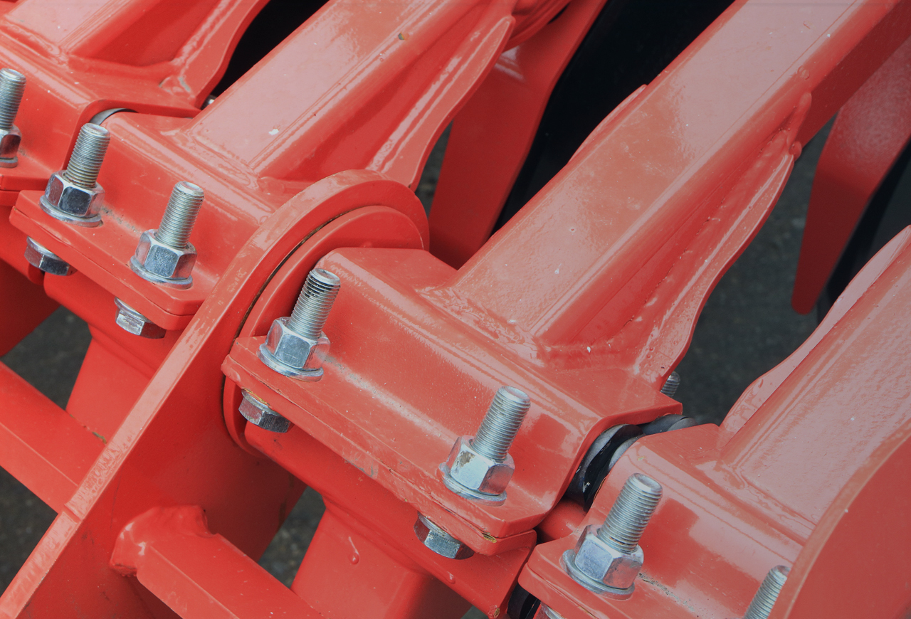 Close up of parts of combine bolted together