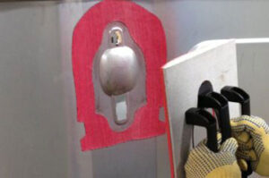 Close up of handles being applied to metal surface with adhesive