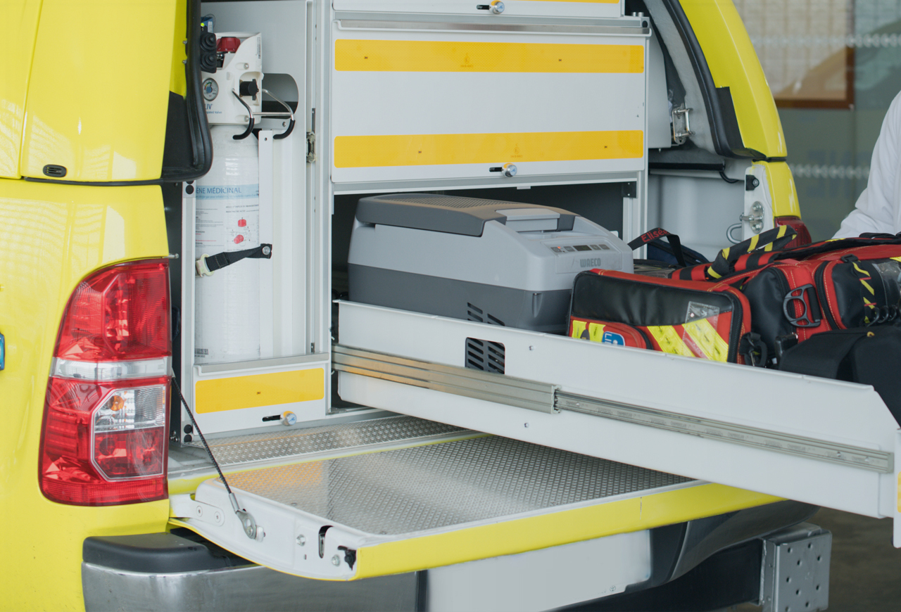 Large drawer open on emergency vehicle full of medical supplies