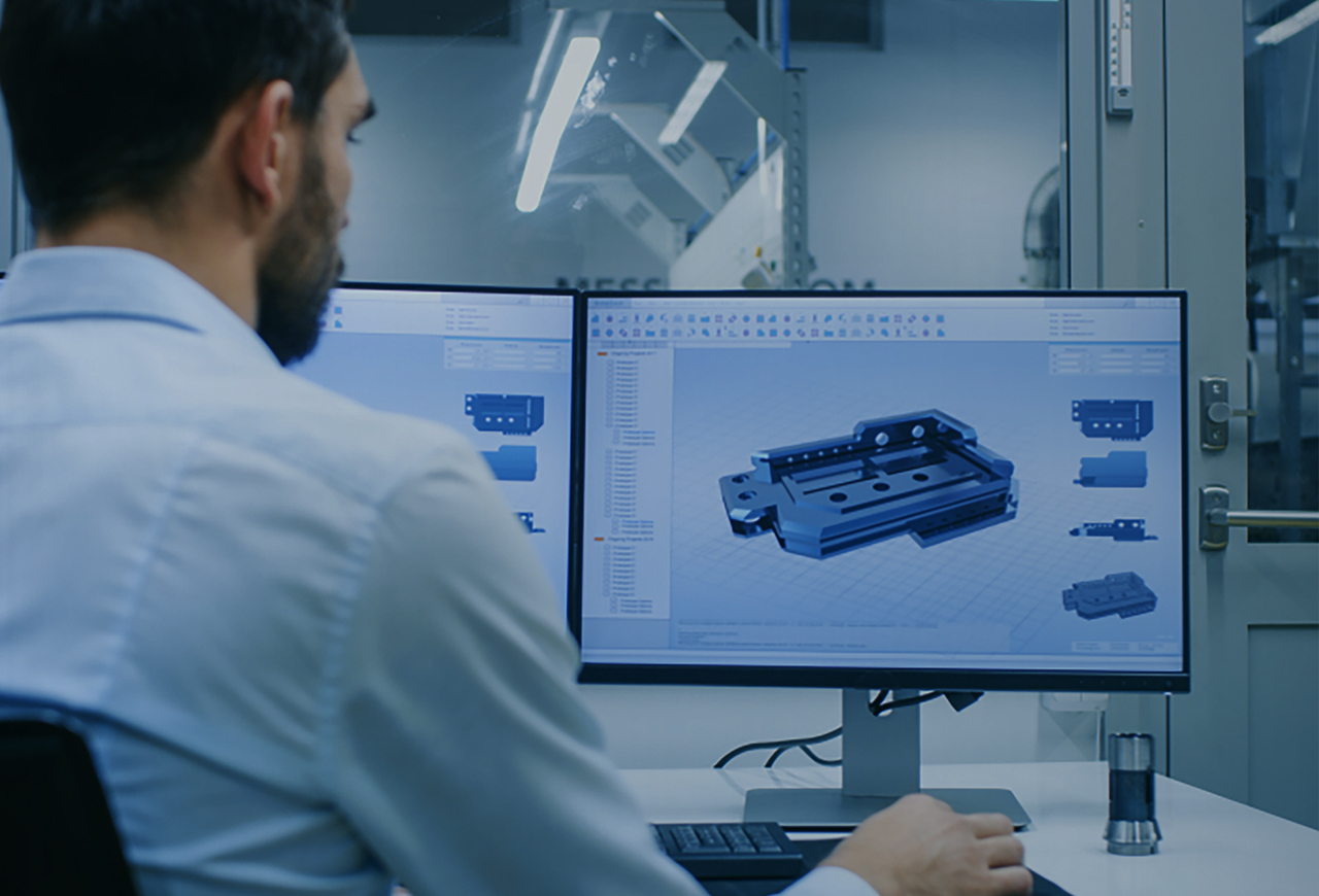 Engineer at a computer with CAD drawing