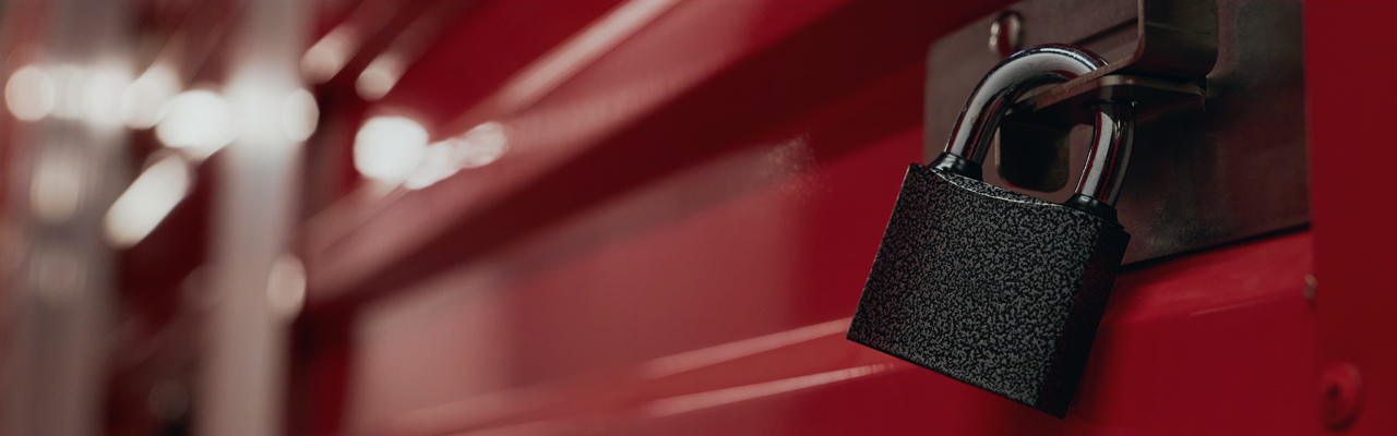 Close up of padlock on red metal door