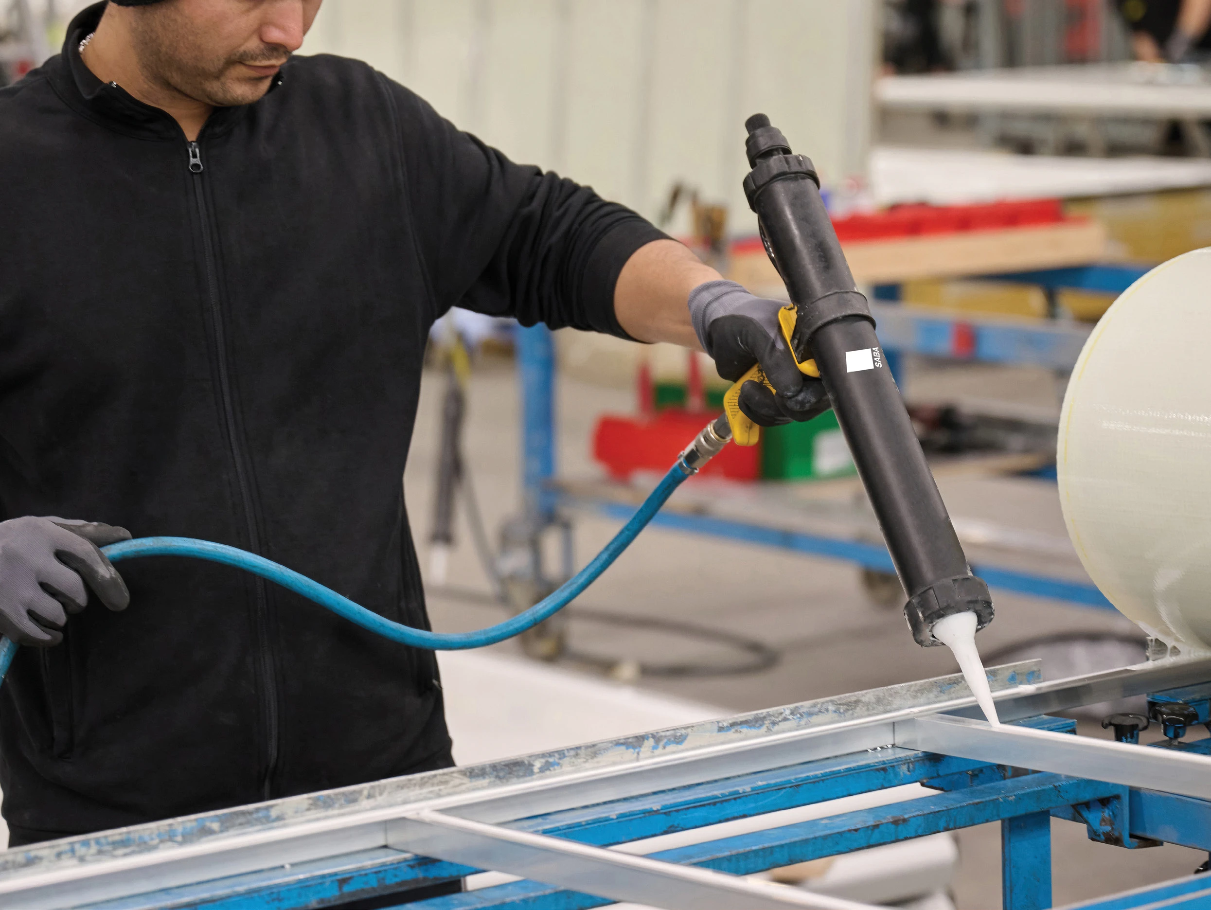 SABA adhesive being applied to a metal frame