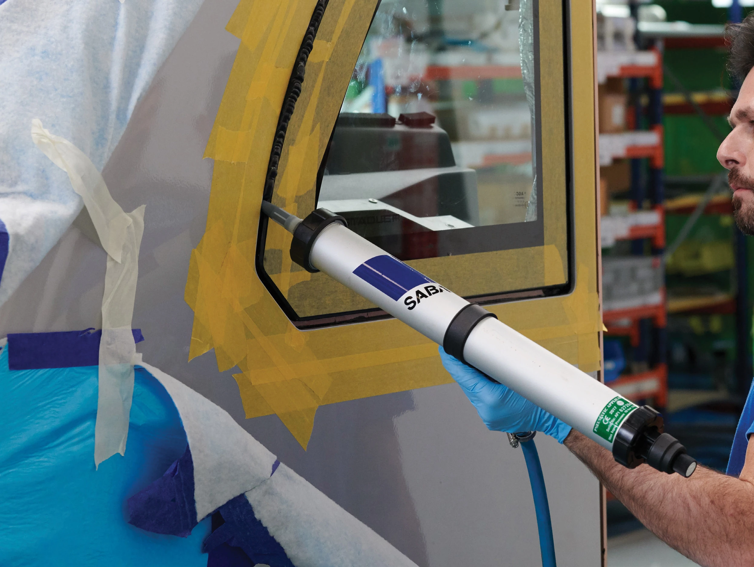 SABA adhesive being applied to a vehicle window