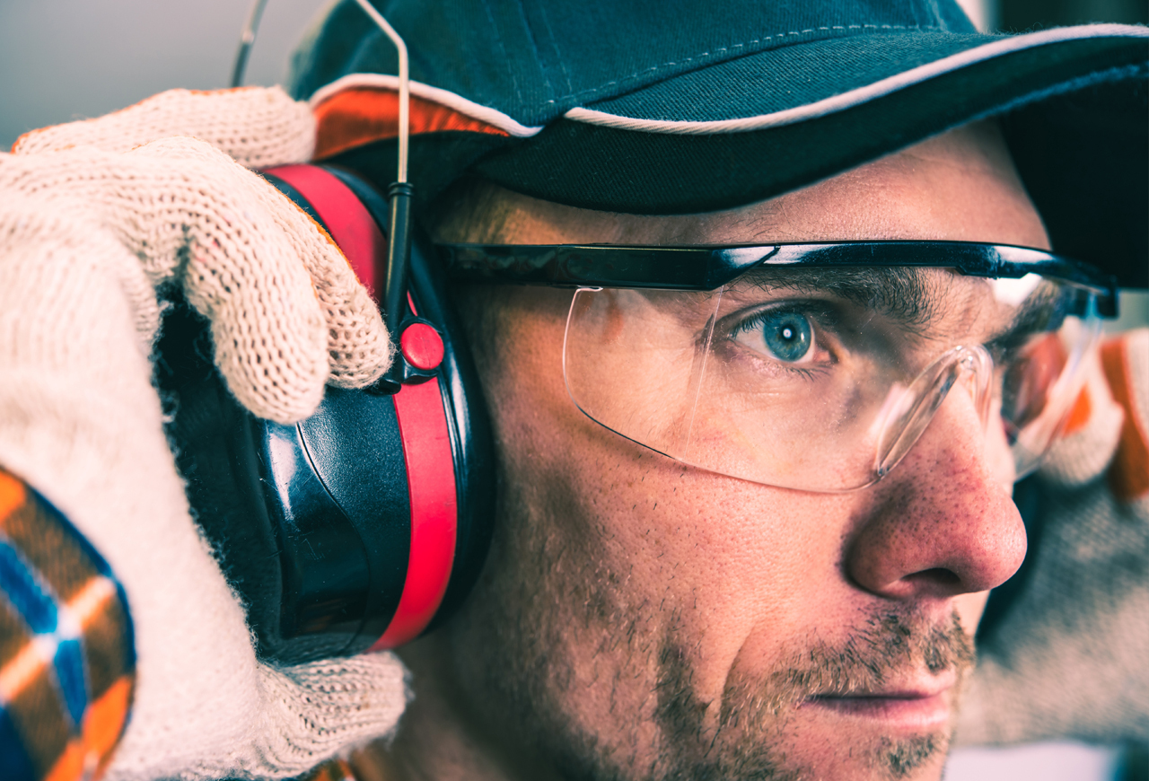 Man Wearing Eye Goggles and Ear Protectors