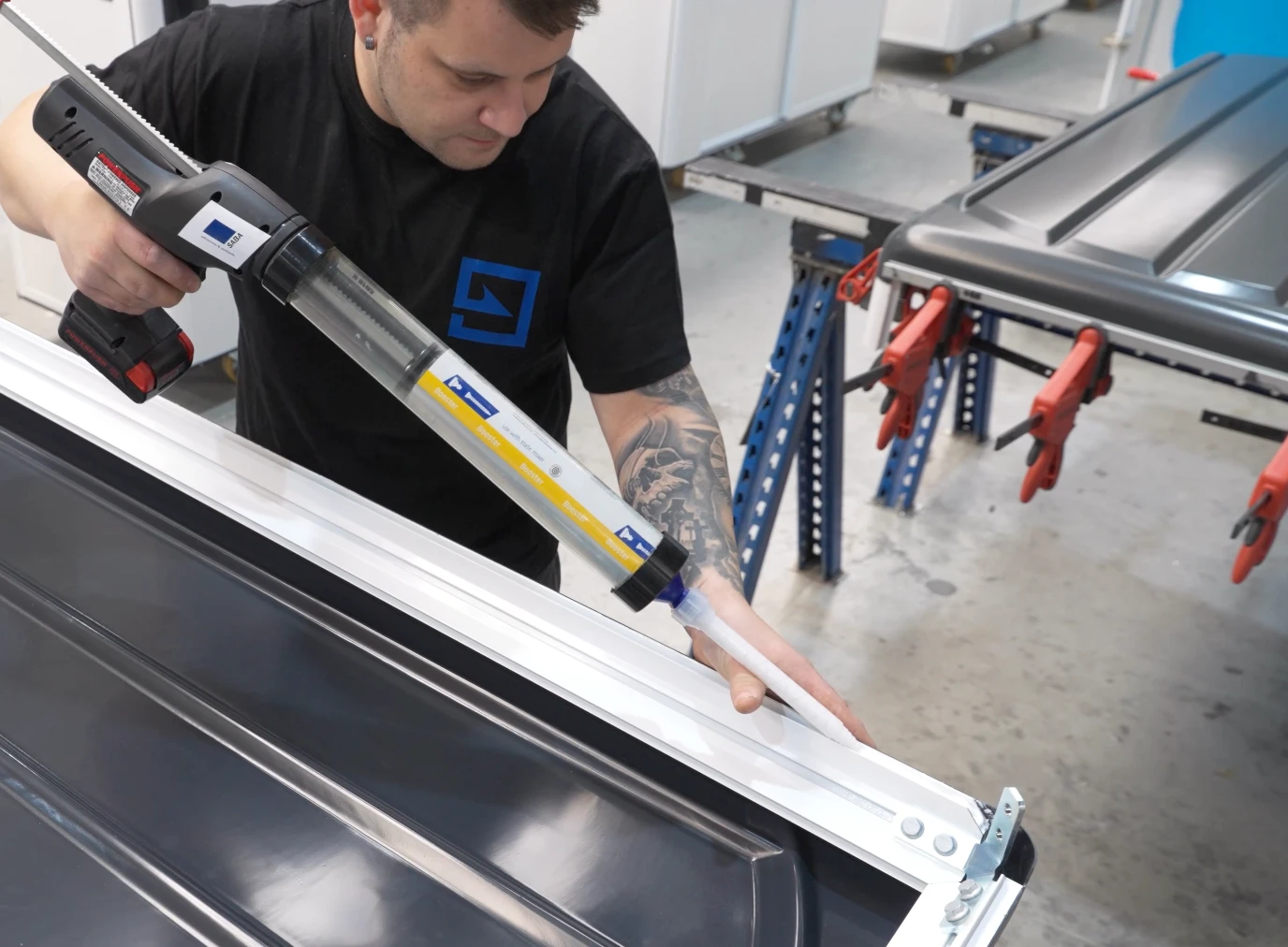 SABA adhesive being applied to a metal panel