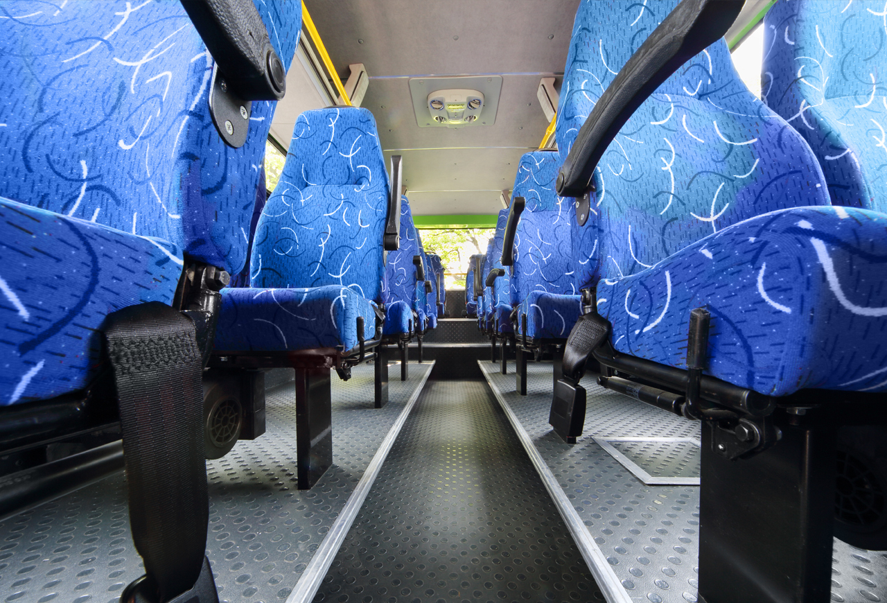 Interior of motorcoach bus showing rows of blue seats