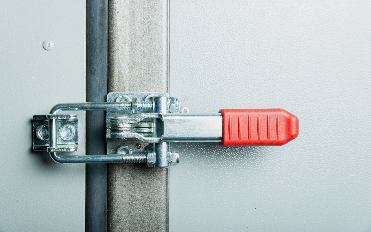 Toggle clamp on compartment door