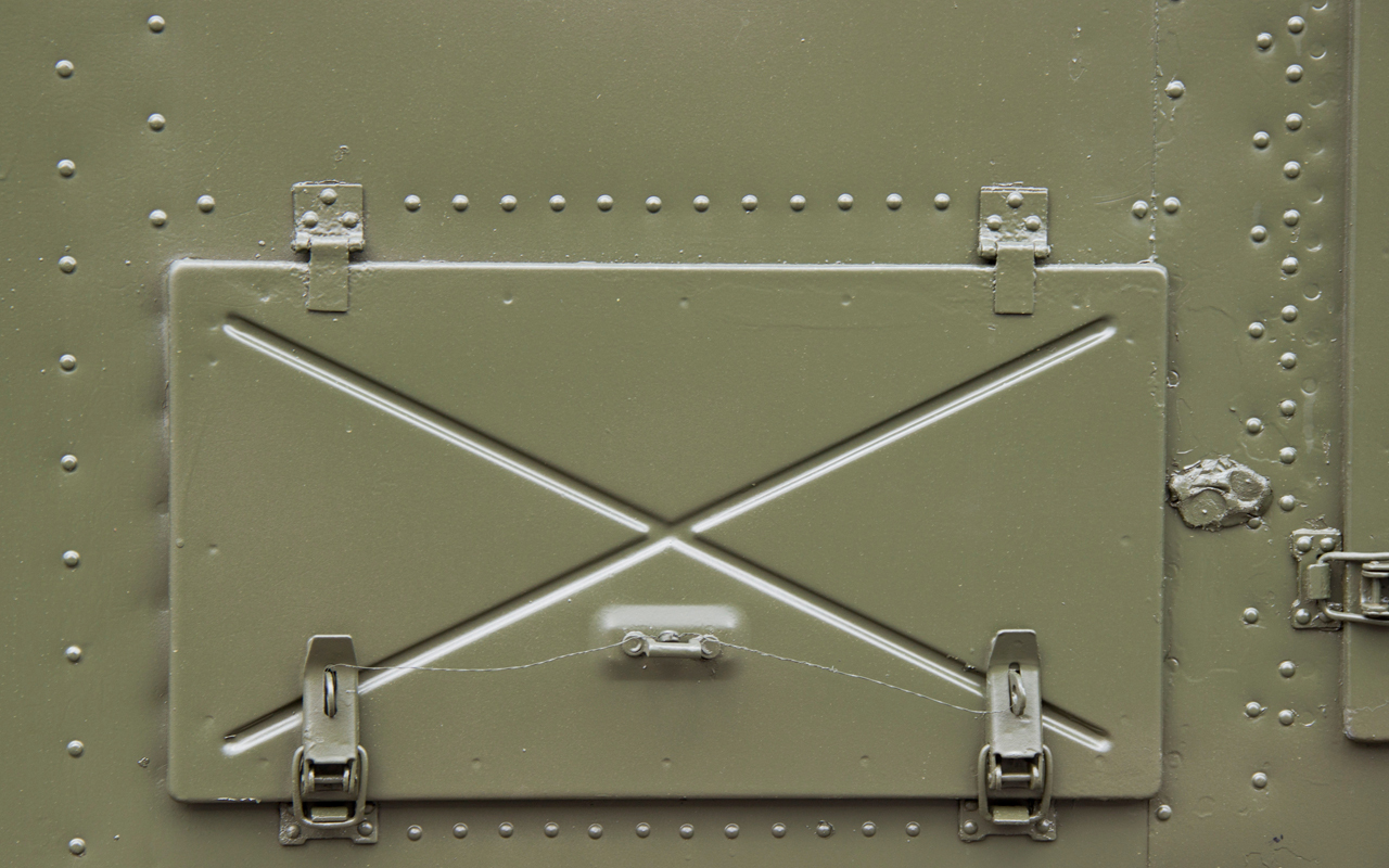 Toggle clamps on hatch door of military vehicle