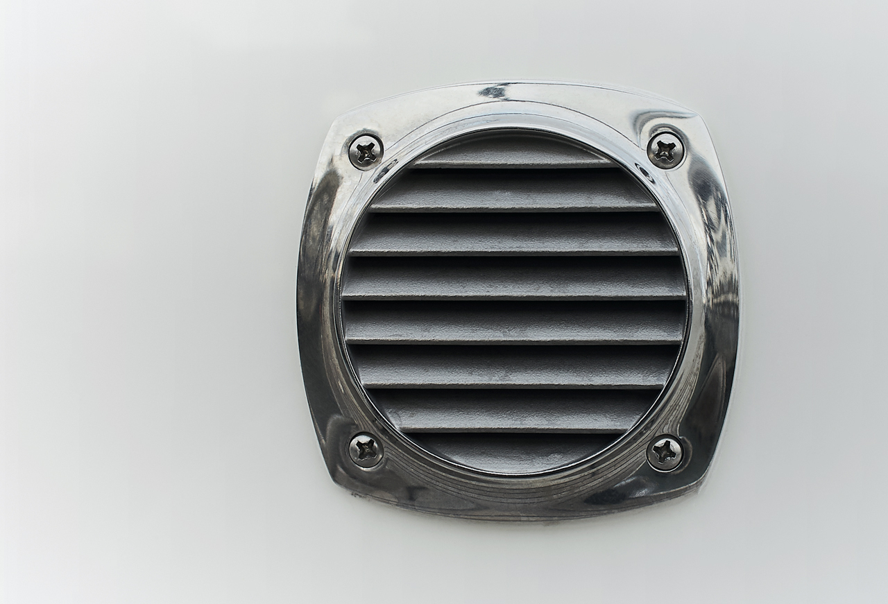 Metal crcular louvered vent in the side of boat 