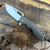 A2D Attn2Detail Mercantile Mark 1 Medium Folder S/E Stonewash Flow Titanium Handle Satin Magnacut Rising Grind Blade