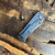 John Gray Rostrum T/E  Blue Ano Titanium Handle  Carbon Fiber Top Black Rain Magnacut Blade Blue Rocked Backspacer