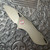 Grissom Knife and Tool Riverstone Frame Lock Titanium Handles w/ Pink Pivot Collars Stonewashed Blade