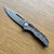 John Gray Custom Slitter V2 Frame Lock Ported Copper Camo Carbon/Ported Titanium Handle Dark Rain MagnaCut Blade
