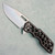 A2D Attn2Detail Mercantile Mark 1 Medium Gen 4 Folder S/E Blackened Voronoi Skelly Titanium Handle Stonewash Satin Magnacut Rising Grind Blade