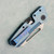 Winterblade Factor B4 M-Lock Blue Textured Titanium Handle w/ Black/ZurcuTi Accents Stonewash MagnaCut Blade (Consignment) Clip Side