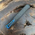 Heretic Knives Cleric II D/E Carbon Fiber Top Cover Aluminum Back w/ Carbon Fiber Inlay DLC Blade Blue Ti Accents H020-6A-CF/BLU