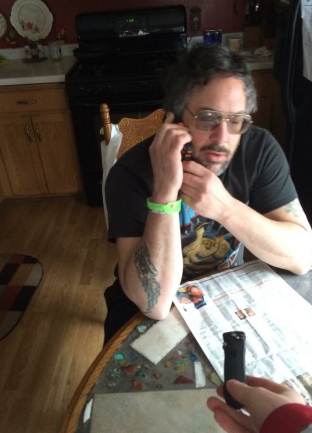 Jay taking a phone order at the table of the original location of American Edge