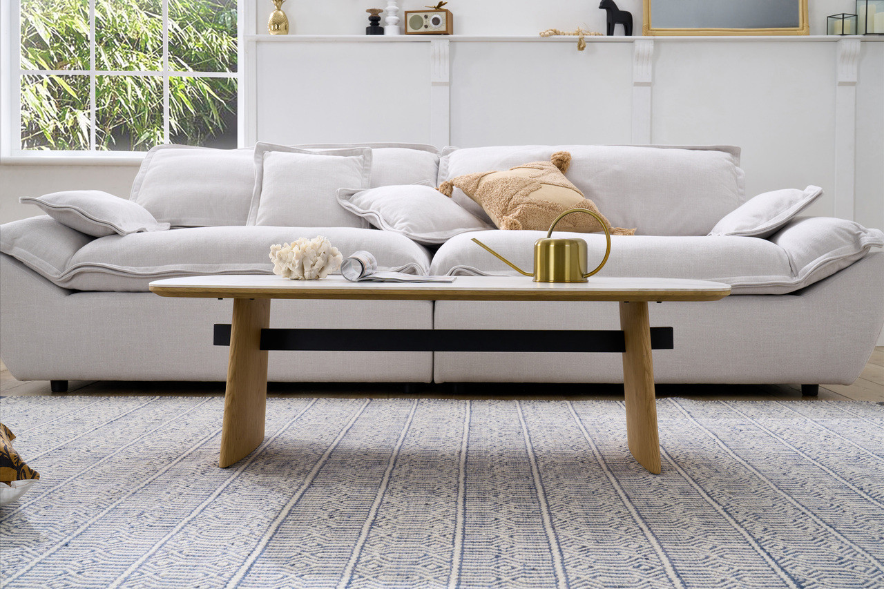 Cara coffee table with matte white carrara-look ceramic top and natural oak finish, contemporary round coffee table