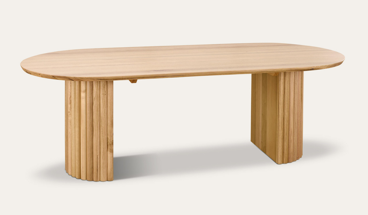 Carrera dining table in Tasmanian oak timber with fluted detailing, curved silhouette, and natural water-based finish, modern timber dining table