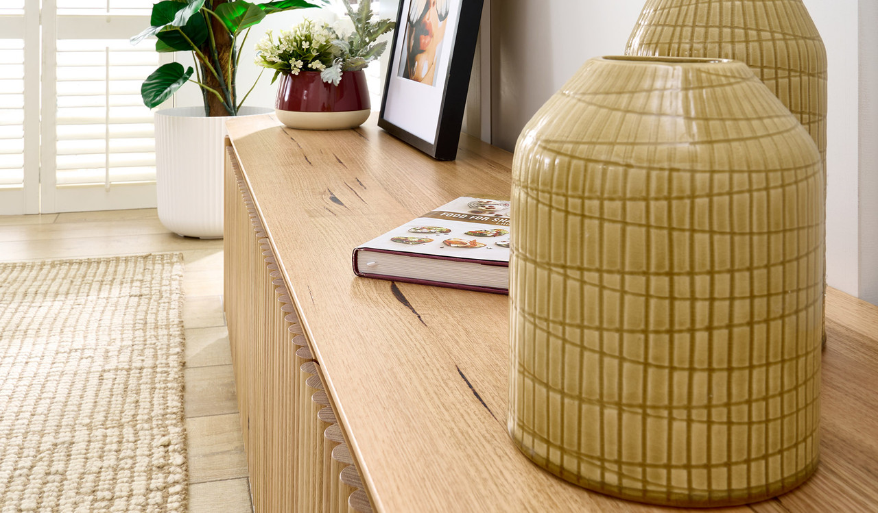 Carrera entertainment unit in Tasmanian oak timber with fluted detailing, curved silhouette, and natural water-based finish, modern timber TV cabinet