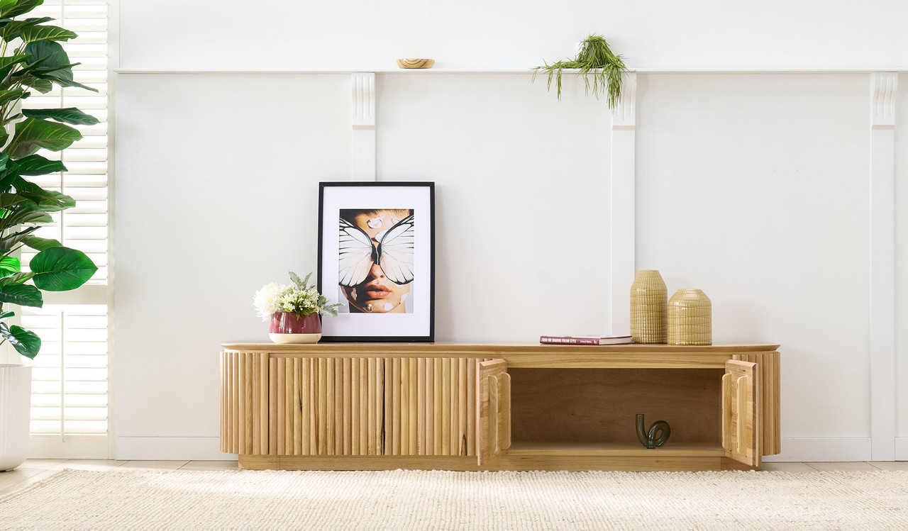 Carrera entertainment unit in Tasmanian oak timber with fluted detailing, curved silhouette, and natural water-based finish, modern timber TV cabinet