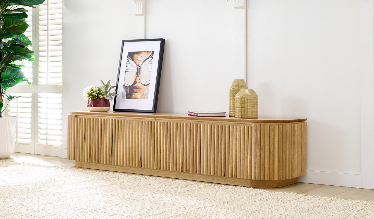 Carrera entertainment unit in Tasmanian oak timber with fluted detailing, curved silhouette, and natural water-based finish, modern timber TV cabinet